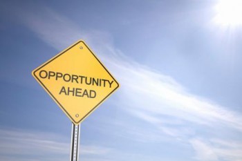 road sign in front of blue sky, that says "Opportunity ahead"