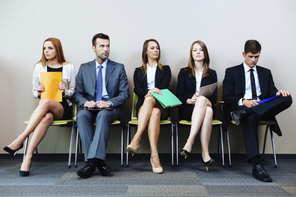 image of professionals sitting in a row in a waiting room