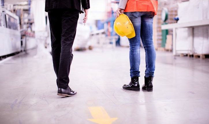 close up of the legs of people standing in warehouse environment