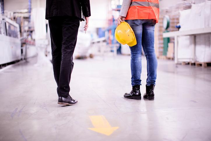 close up of the legs of people standing in warehouse environment