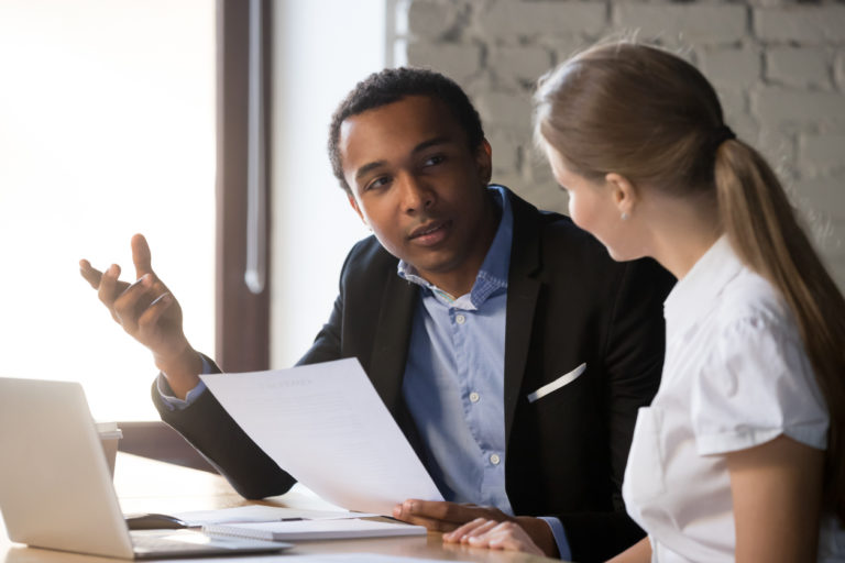 African american boss negotiating discussing contract details with company corporate woman client. Black hr manager interviewing young female job candidate. Employment hiring human resources concept