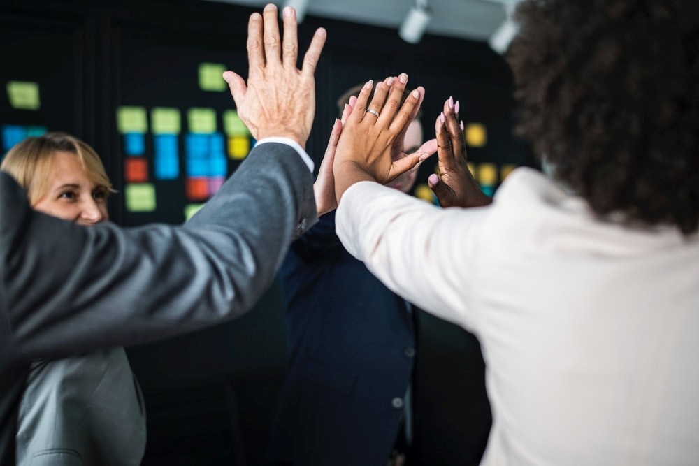 colleagues giving each other high fives