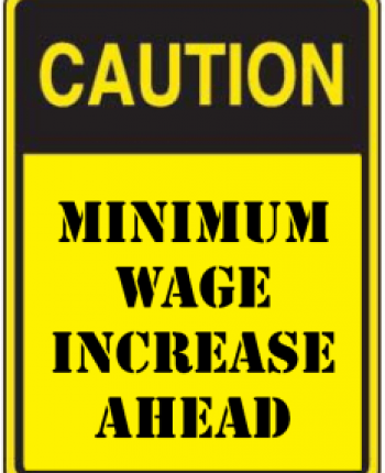 caution sign with text "minimum wage increase ahead"