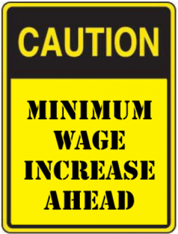 caution sign with text "minimum wage increase ahead"