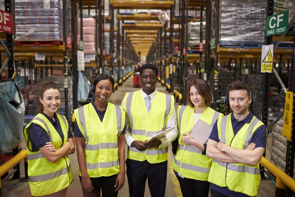 warehouse team mates in reflective vests