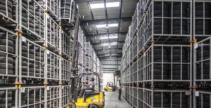 internal view of a tire warehouse and forklift removing a pallet of tires