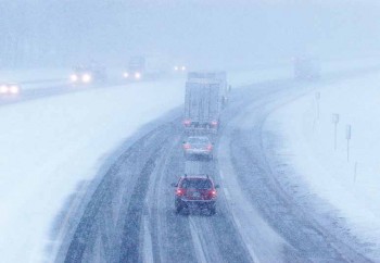 cars on a very snowy highway