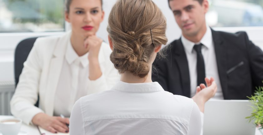 3 people speaking across a table as if in an interview