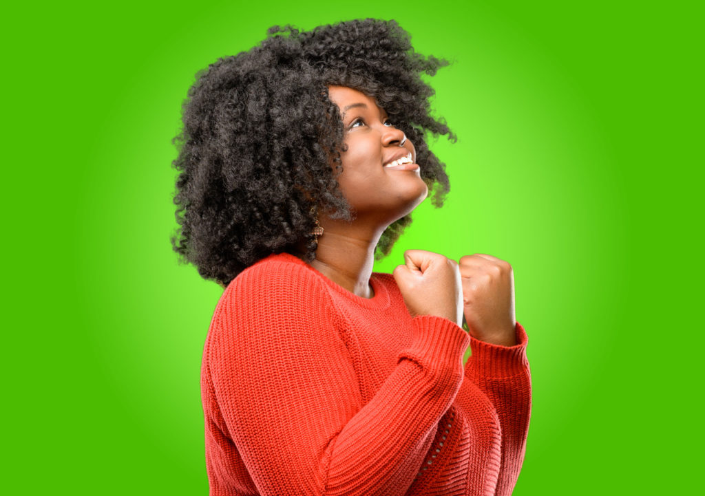 Young woman looking excited and smiling broadly