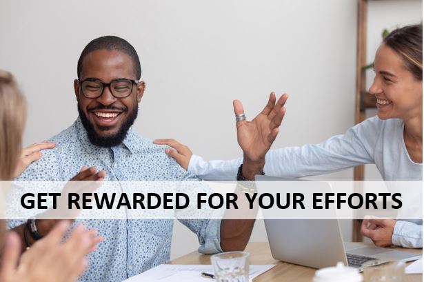 man being cheered on by colleagues at a meeting table and text that says "Get rewarded for your efforts"