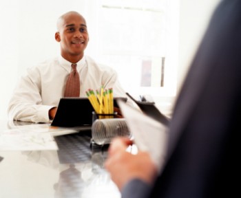 man at laptop across from another person