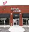 a Service Canada store front facade and Canadian flag.