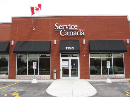 a Service Canada store front facade and Canadian flag.