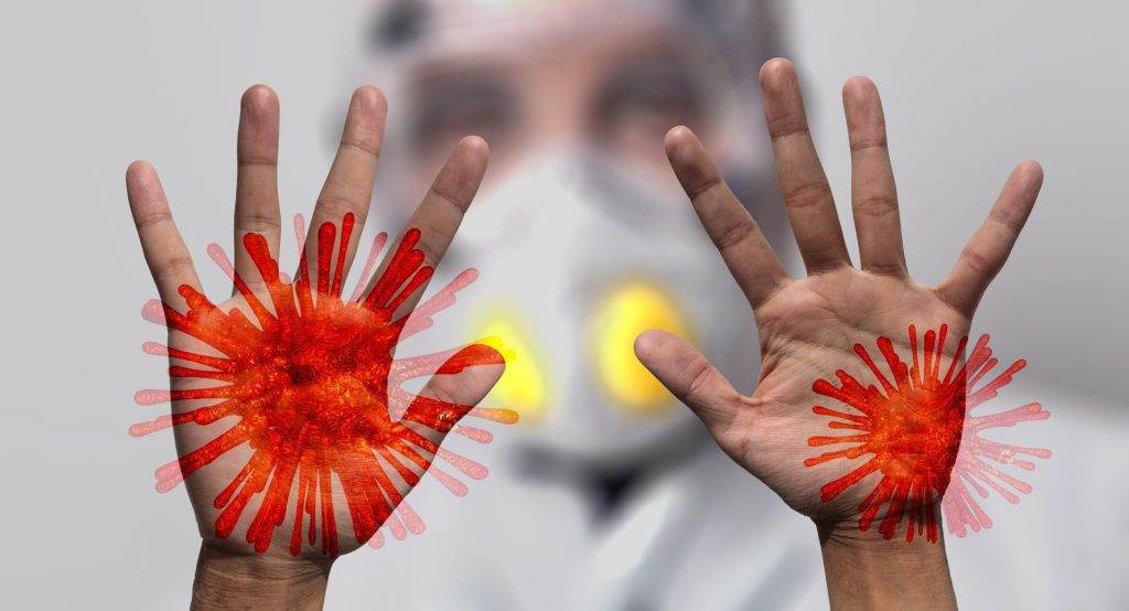 hands with virus molecules superimposed on them