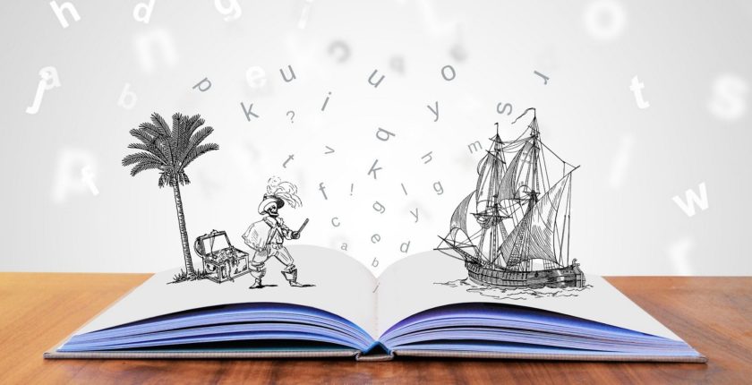 open book with illustration of pirate, palm tree and pirate ship