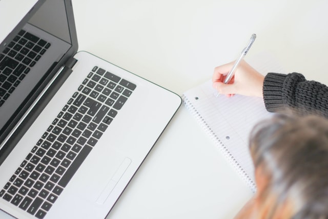 laptop with pen and notepad