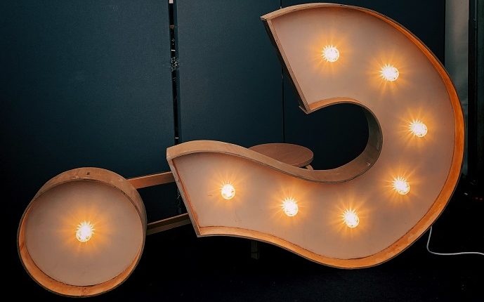 lighted electric sign in shape of a question mark