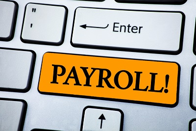 computer keyboard with key for payroll highlighted