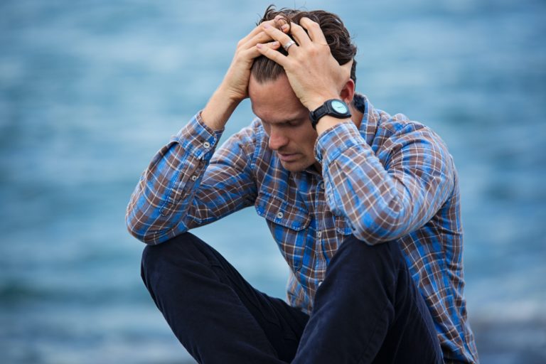 upset man with head in his hands