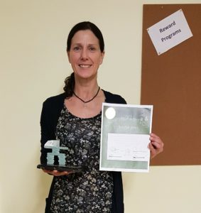 Sue holding her award plaque