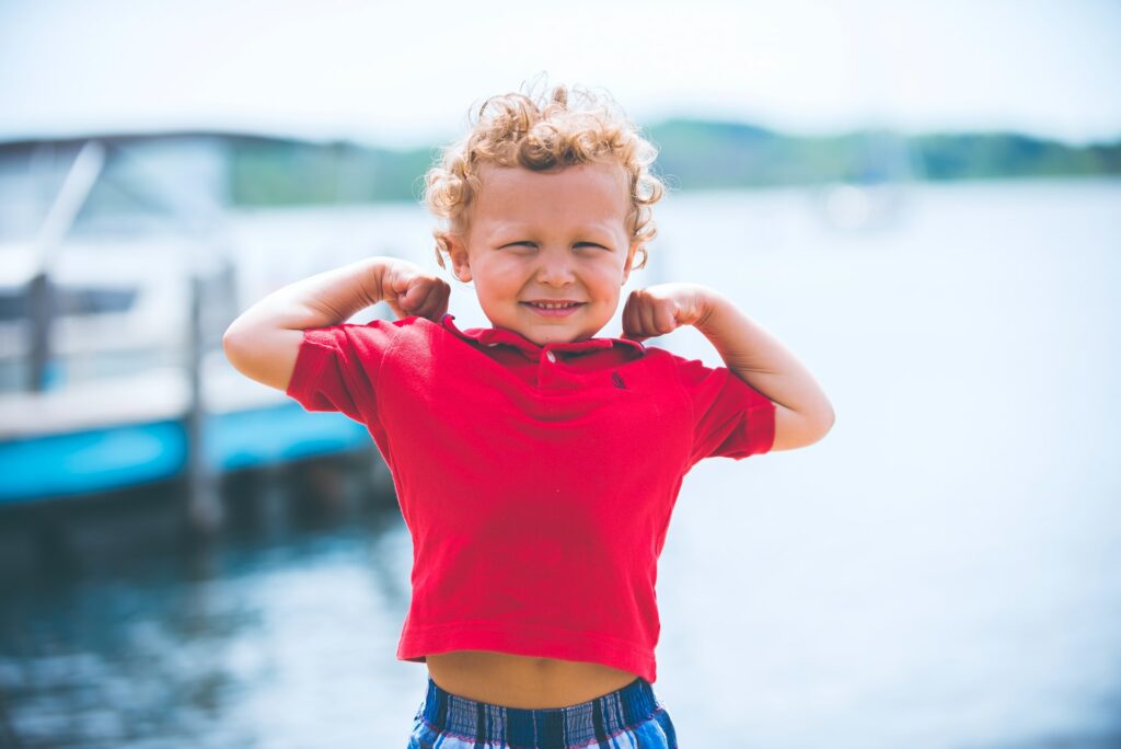 kid showing his muscles