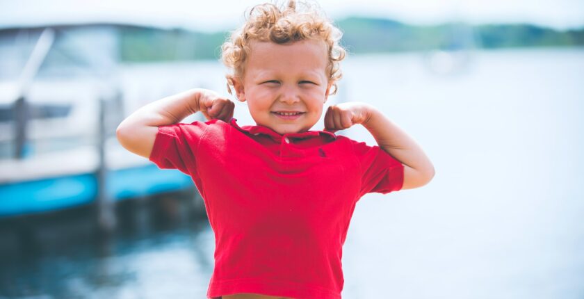 kid showing his muscles