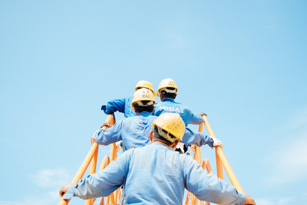 Workers walking up a gangplank