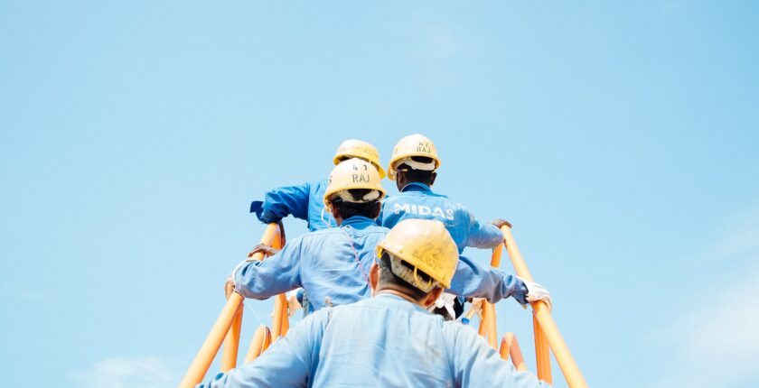 Workers walking up a gangplank