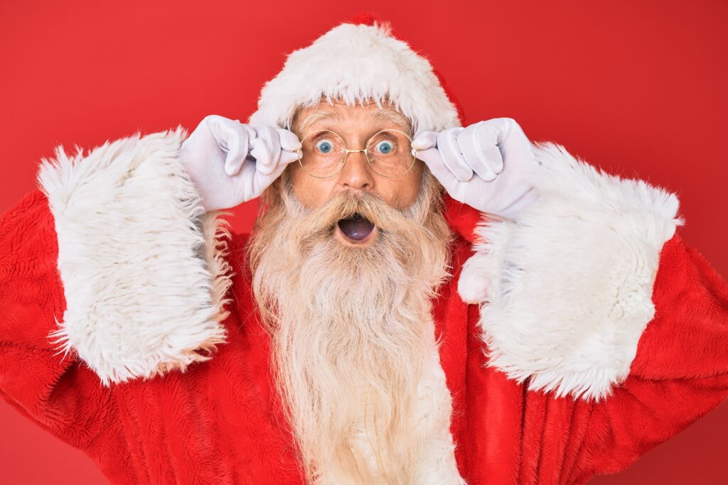 Man dressed as Santa Clause with a shocked or surprised expression on his face