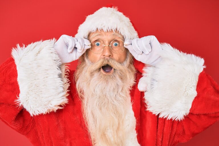 Man dressed as Santa Clause with a shocked or surprised expression on his face