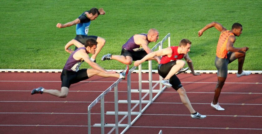 athletes jumping over hurdles - slow interview