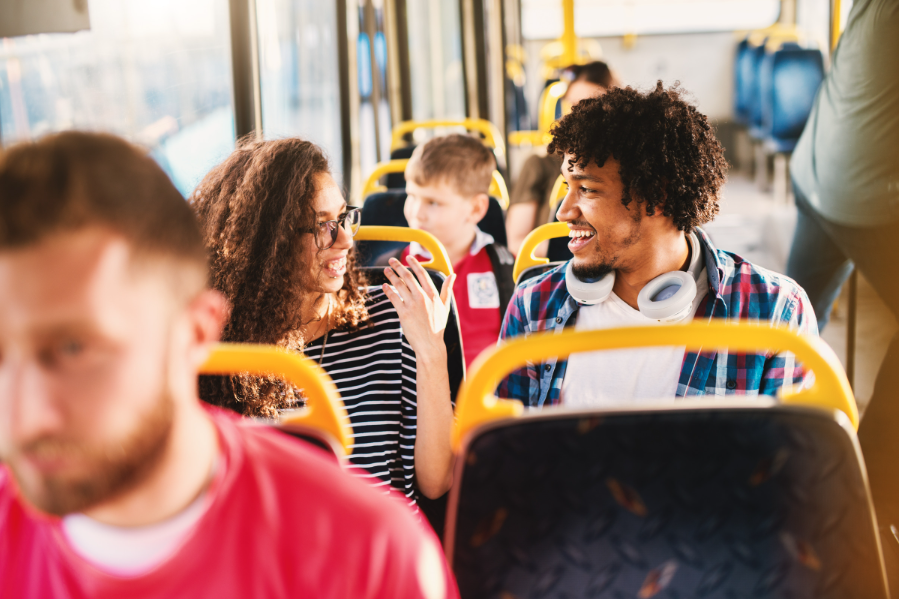 Passengers chat on a bus