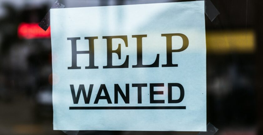 Help wanted sign in a window.