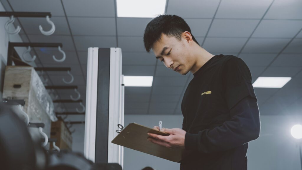 Man holding clipboard checking a list