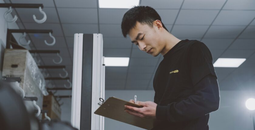 Man holding clipboard checking a list